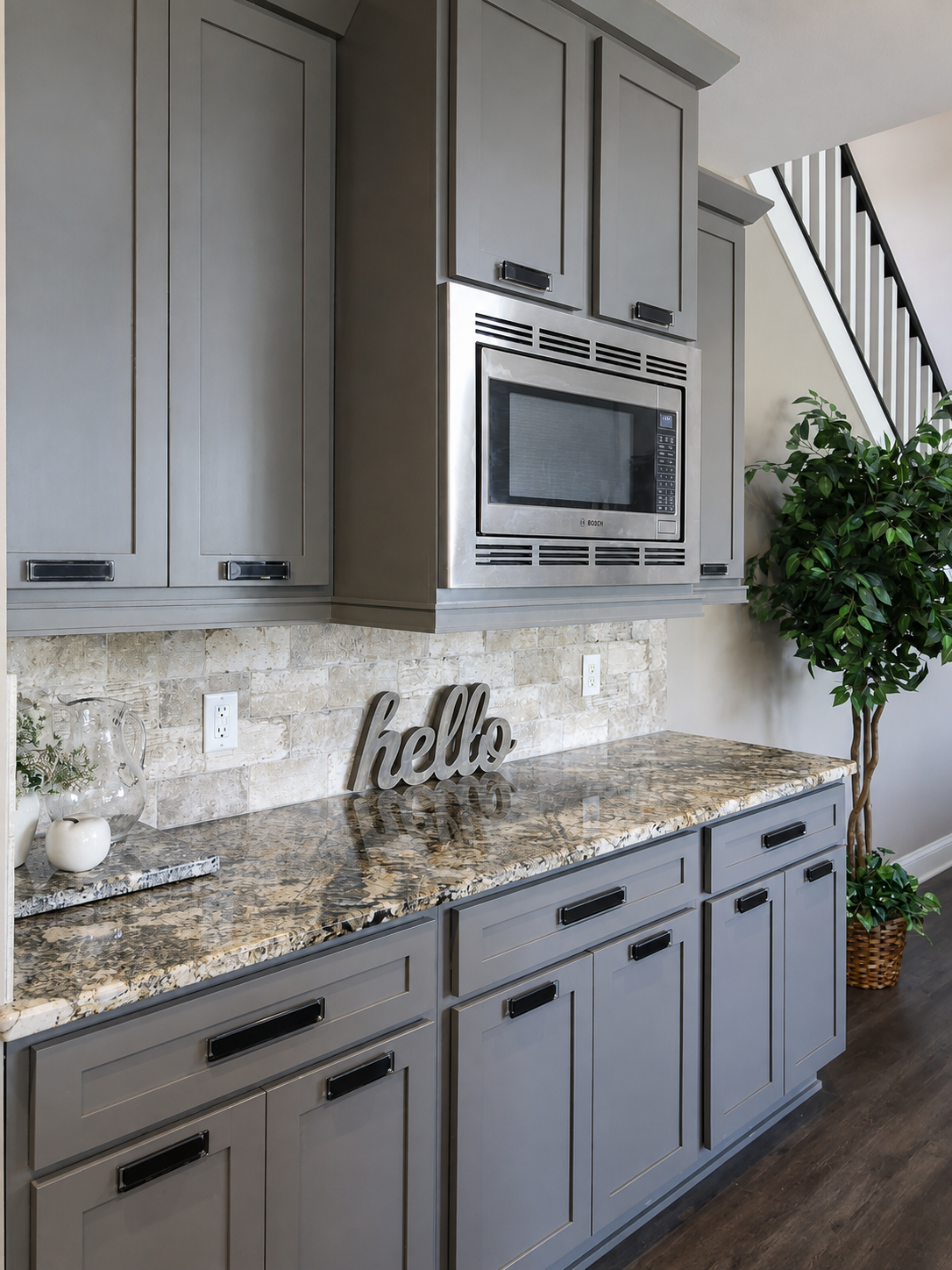 Built-in microwave, cabinetry and granite counter detail